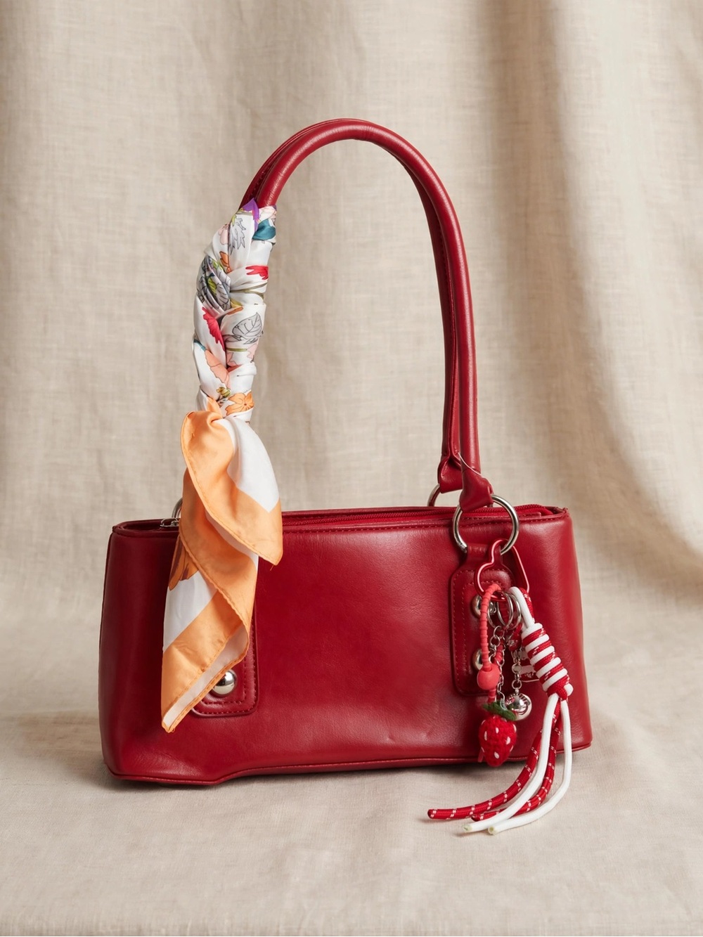 Red Leather Shoulder Bag with Charm and Scarf Accent